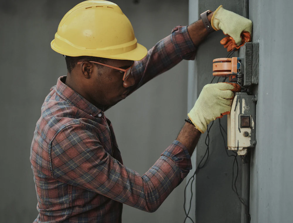A technician working on an electrical panel