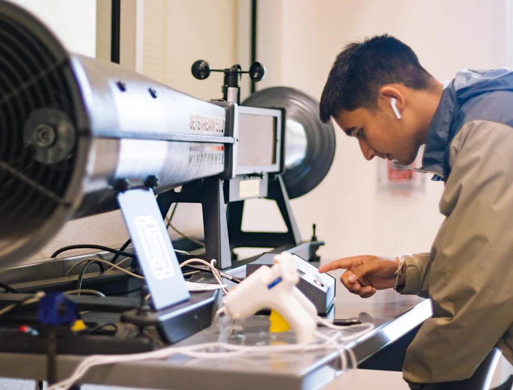 A technician working on serviced equipment